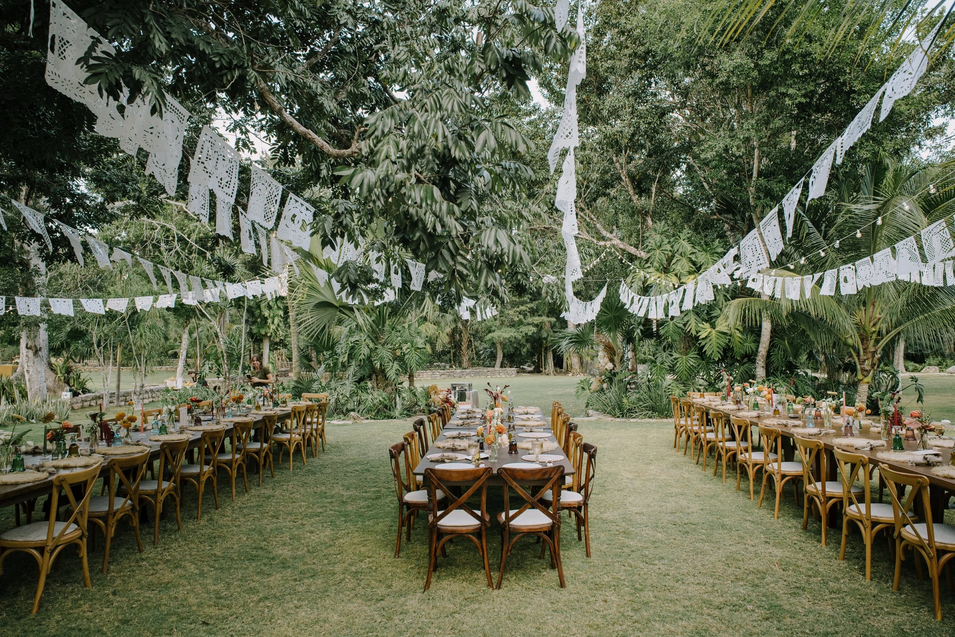 Wedding banquet under papel picado at Onze Xpuha, cenote resort in the Riviera Maya