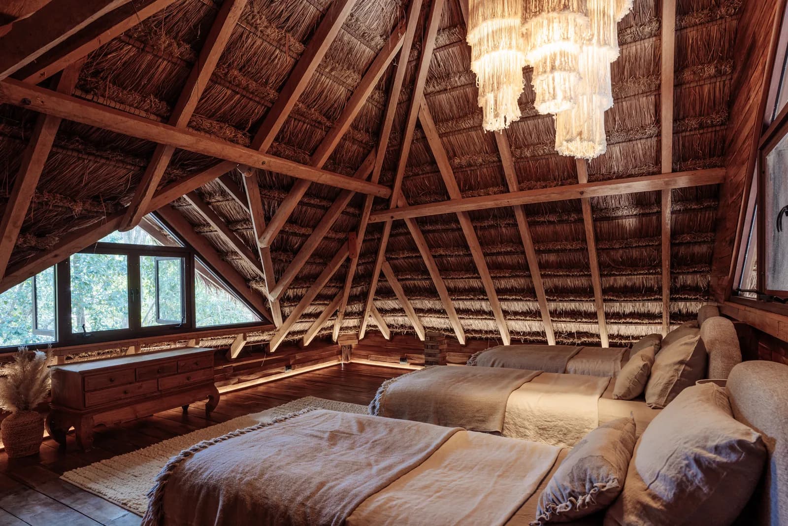 The Lodge exterior, wooden cabin with palapa roof in the jungle