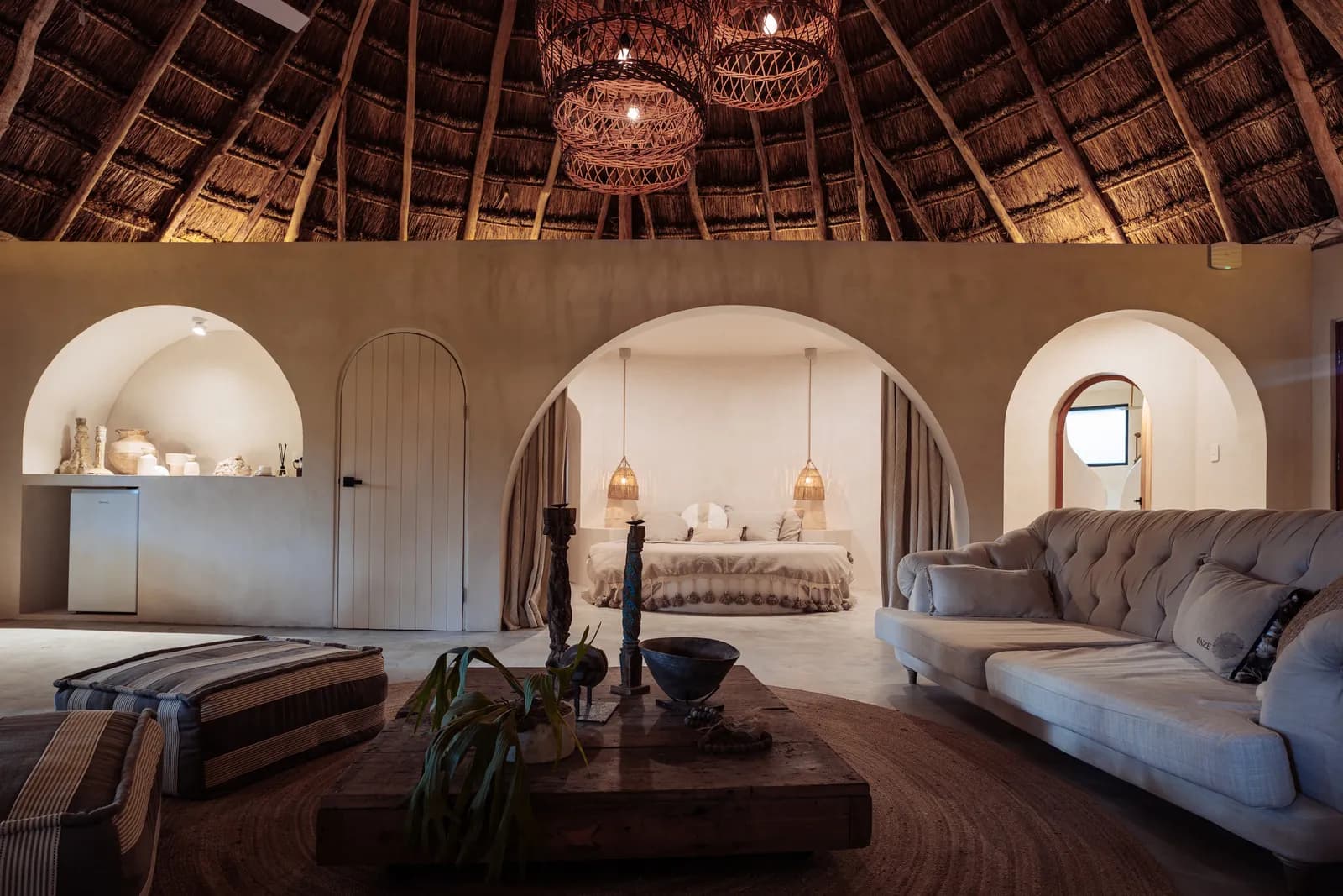 Master Suite great room under a circular palapa with arched openings to the bedroom