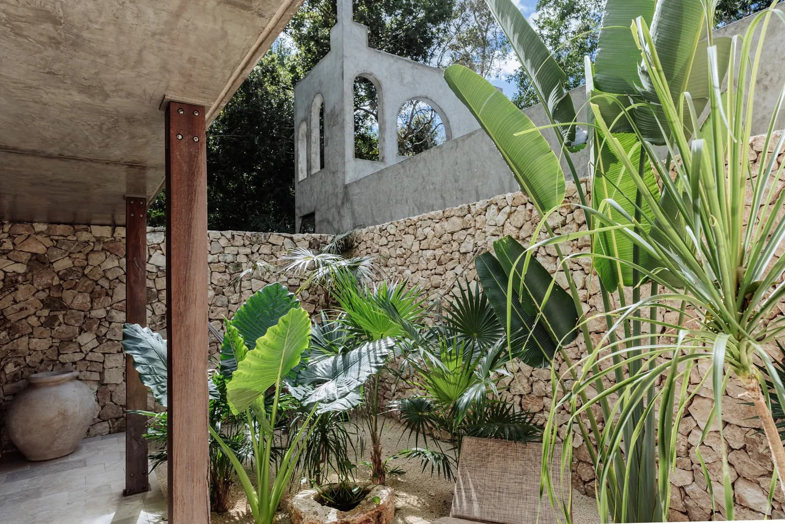 Villa 3 garden view with stone wall and tropical planting