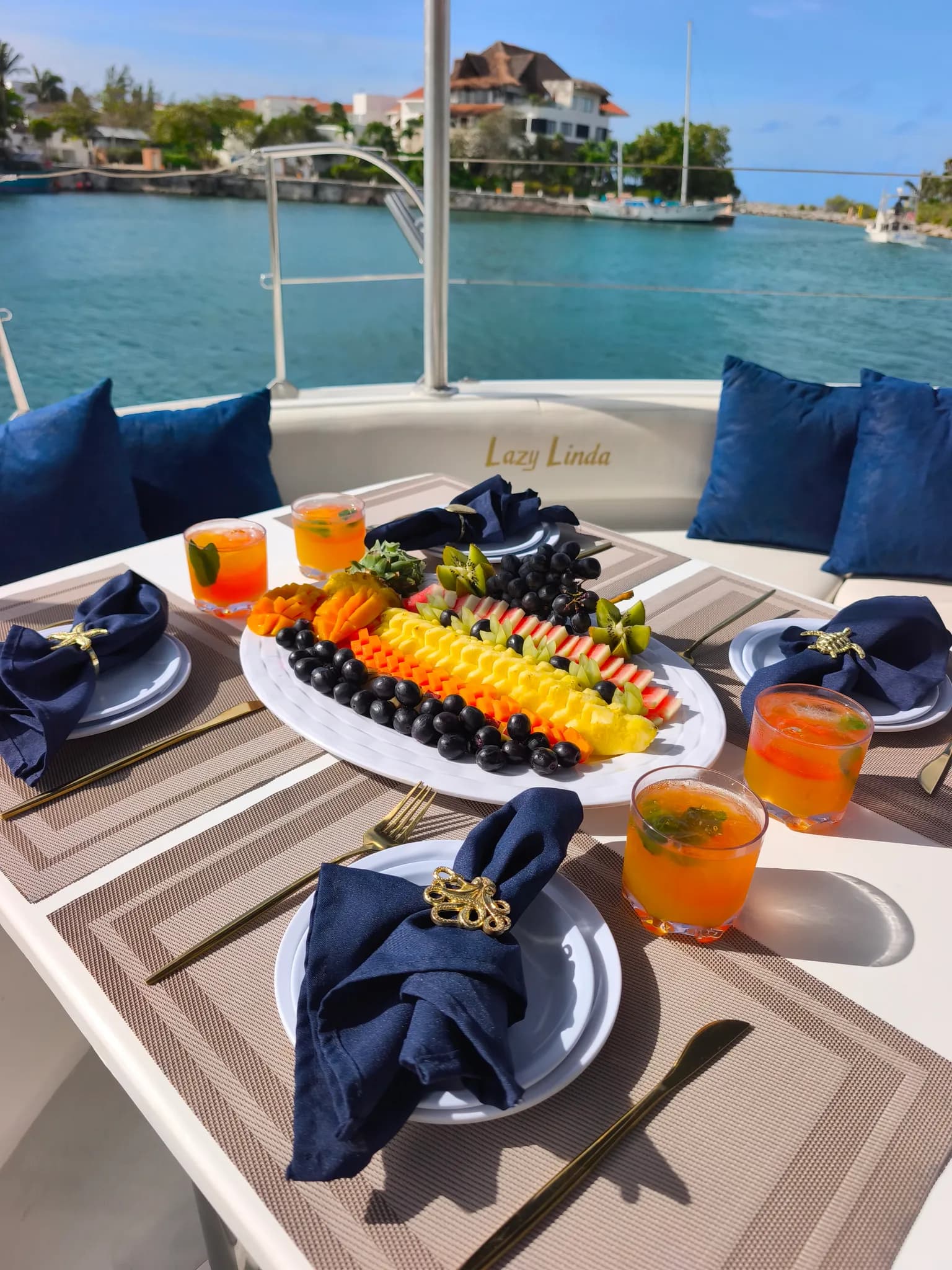 Fresh fruit platter and drinks served aboard a private catamaran day trip