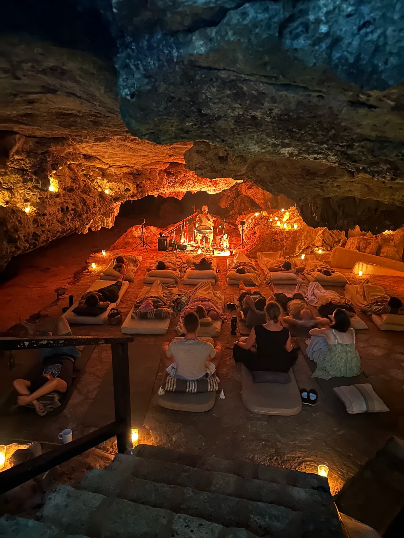Candlelit concert in the underground cenote at Onze Xpuha, guests seated on cushions